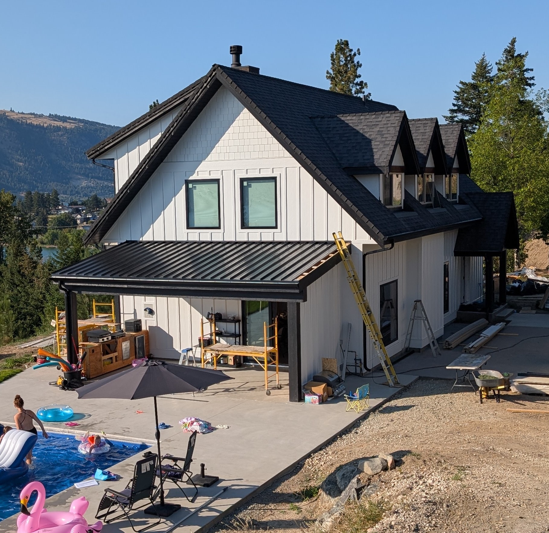 OneKEpp truck beside multi-storey building under construction in snowy mountain setting