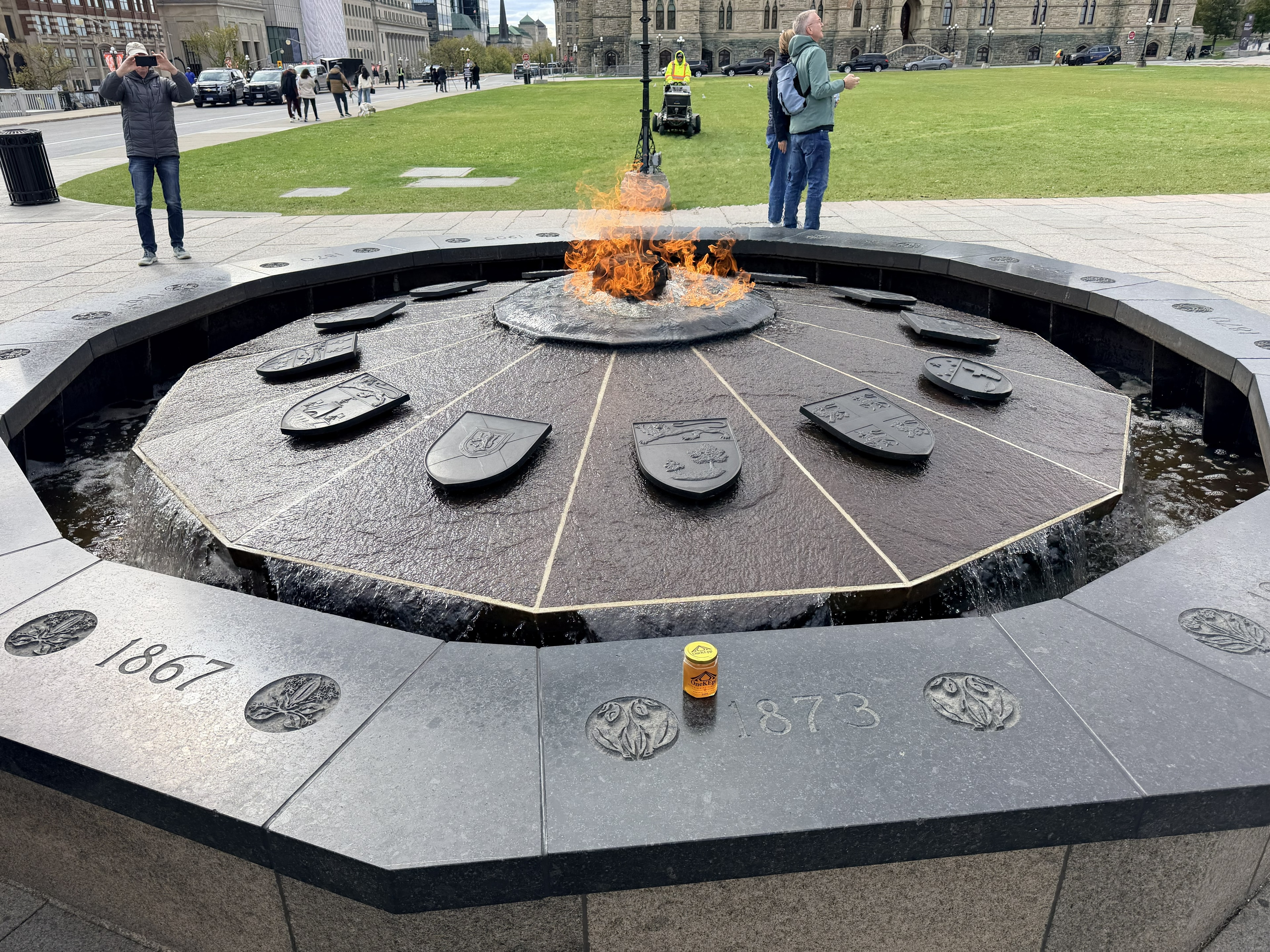 OneKEpp honey jar beside the Centennial Flame on Parliament Hill